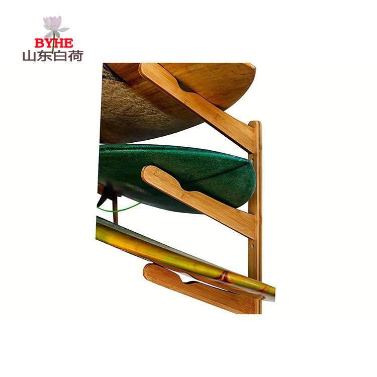 A stand-up surfboard stand-alone stock of bamboo surfboards displays a wall-mounted bamboo frame