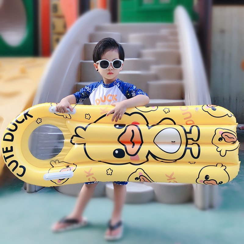 The pontoon inflating surfboard children floating on the water and playing with the floating ducks riding on the flopbed to learn how to swim the waterboard