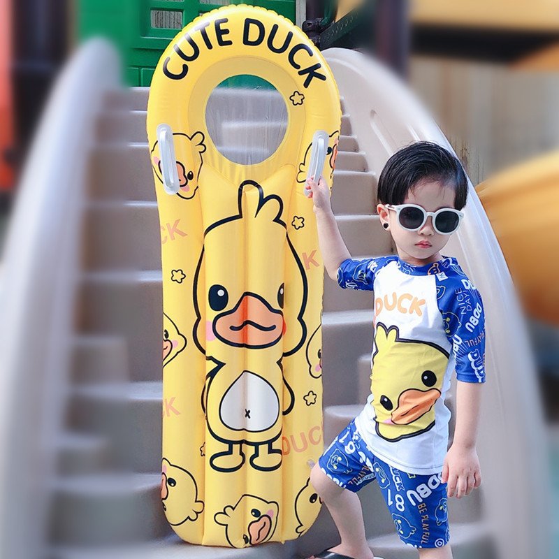 The pontoon inflating surfboard children floating on the water and playing with the floating ducks riding on the flopbed to learn how to swim the waterboard