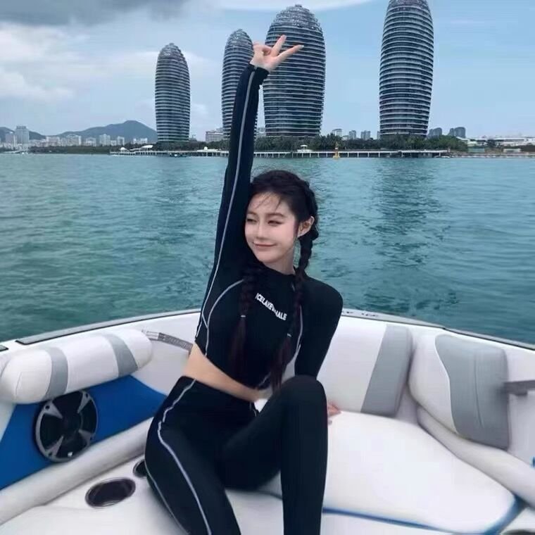 A small, skinny surfer with a long-sleeved, sunproof, dry-dive suit