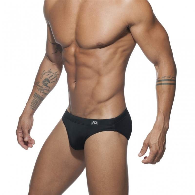 The guy with the swimsuits down his waist with the bikini triangles in a tan, and a sand-basket chute