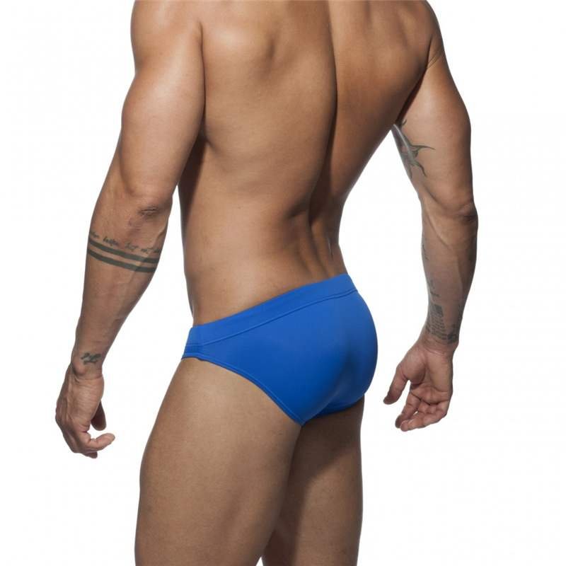 The guy with the swimsuits down his waist with the bikini triangles in a tan, and a sand-basket chute