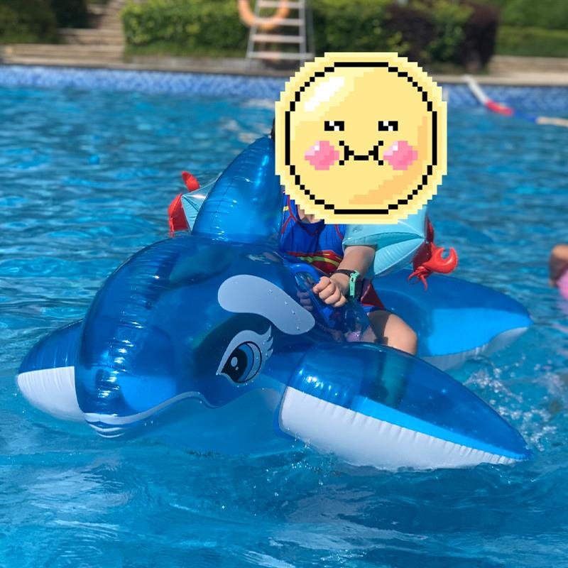 The swimming pool floats on a children's swimming ring and sits on an inflatable super-swipe dolphin whale