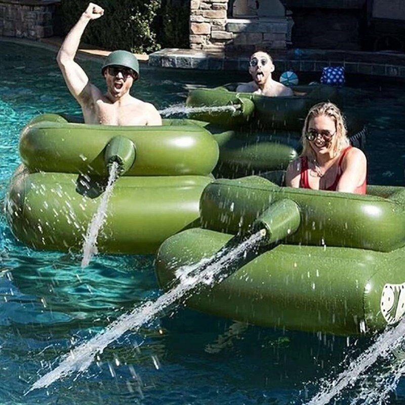 Children surfing on adult boys floating in beach swimming pools on the beach with water guns