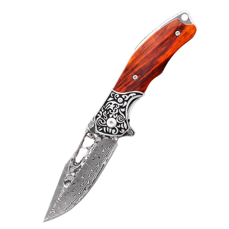Handicrafted Damascus steel folding knife outside the house with a high-intensity fruit knife and a sharp field knife