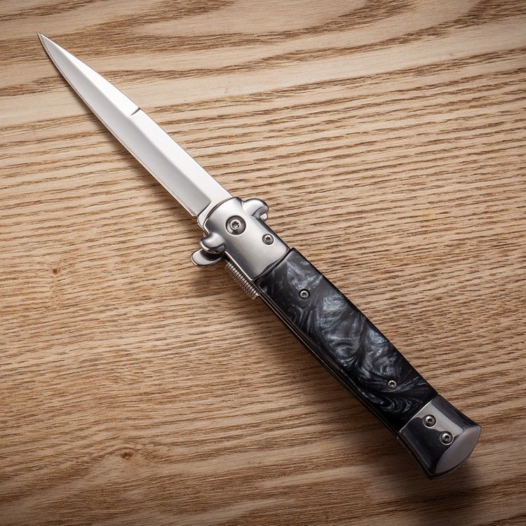An outdoor steel-colored wood handle with a very hard folding of a fruit knife camping with a pedestal knife