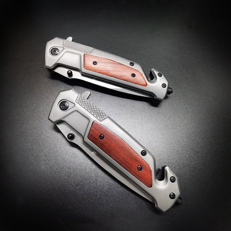 The field camp for a defensive survival knife folds a stainless steel knife to cut a window and cut a rope to survive