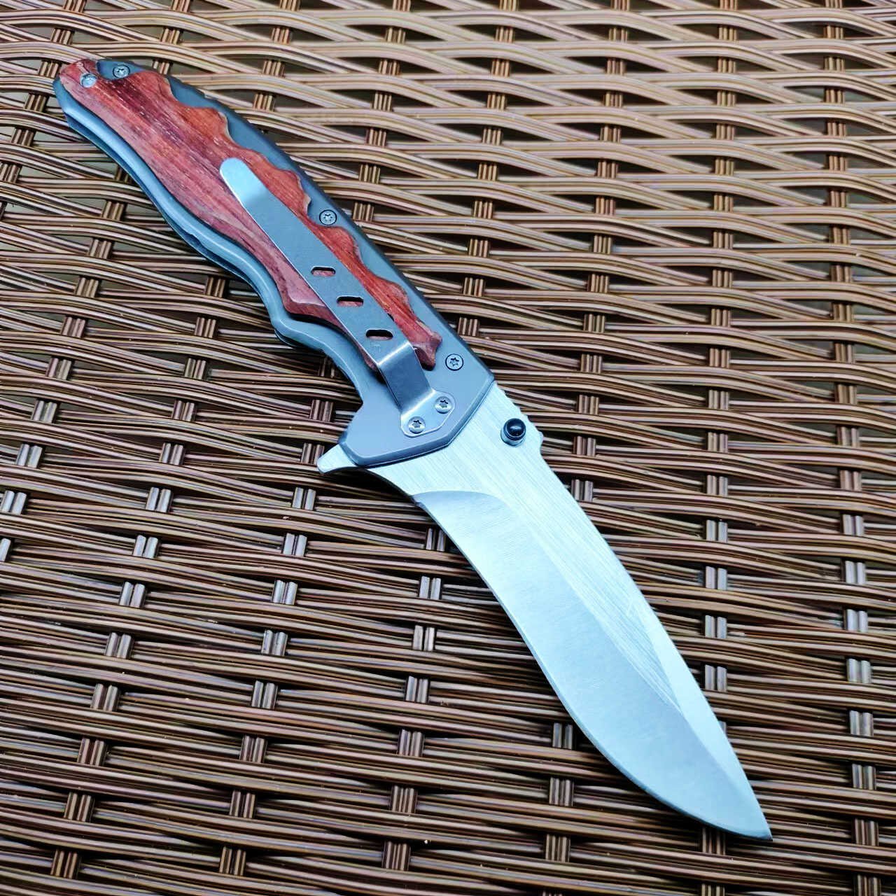 An outdoor folding knife with a high-strength sharp blade and a small knife to protect himself from it