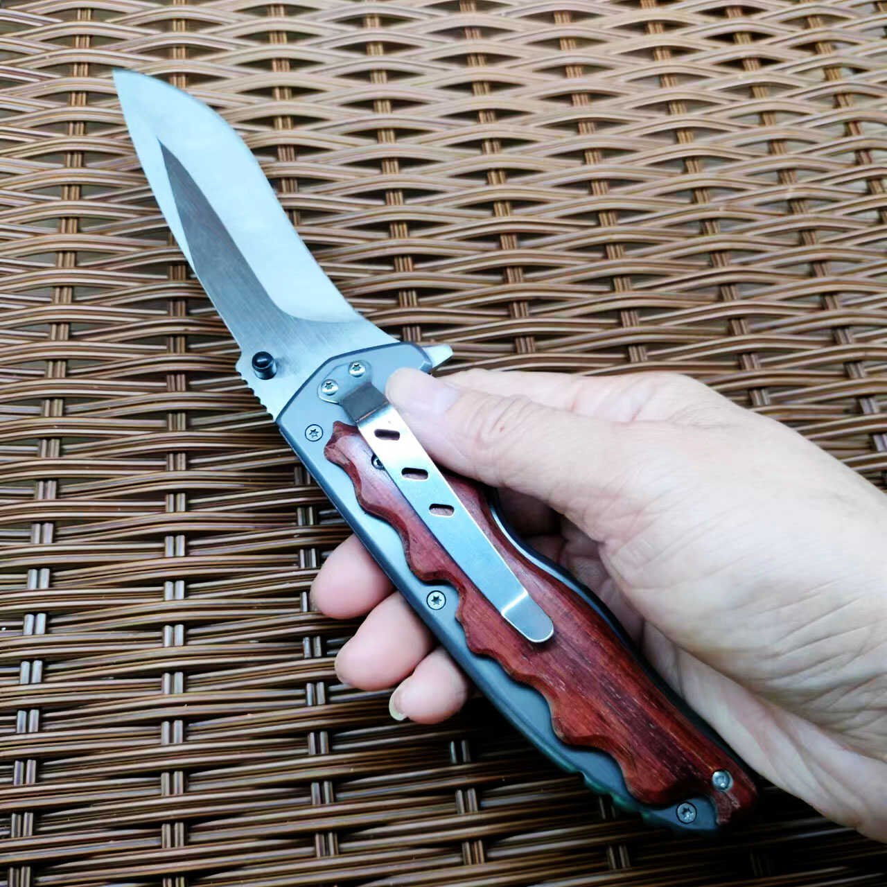 An outdoor folding knife with a high-strength sharp blade and a small knife to protect himself from it
