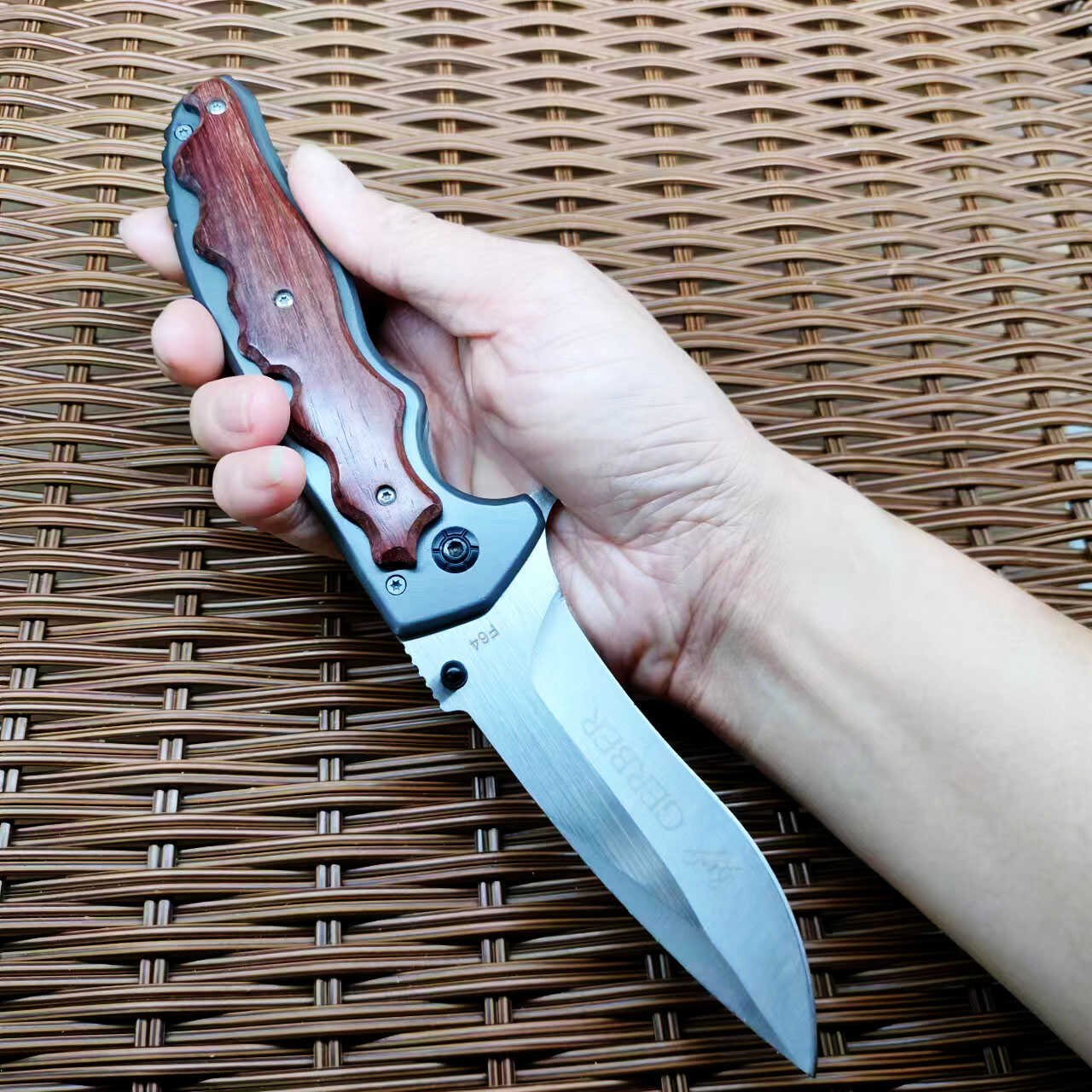 An outdoor folding knife with a high-strength sharp blade and a small knife to protect himself from it
