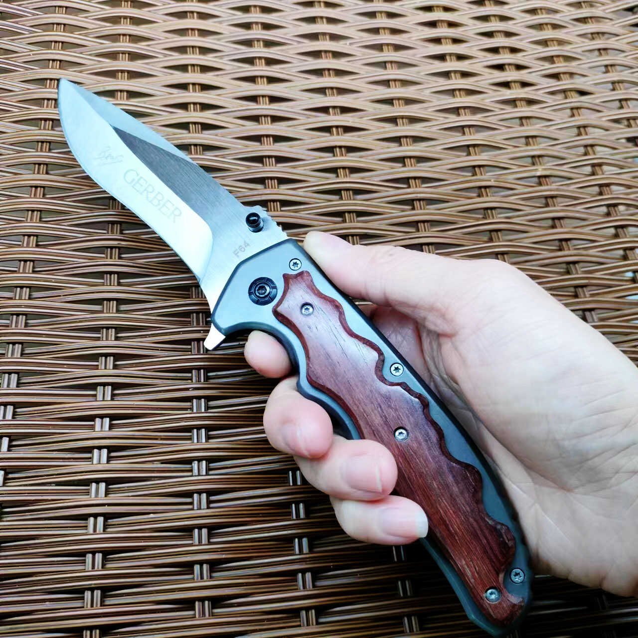 An outdoor folding knife with a high-strength sharp blade and a small knife to protect himself from it