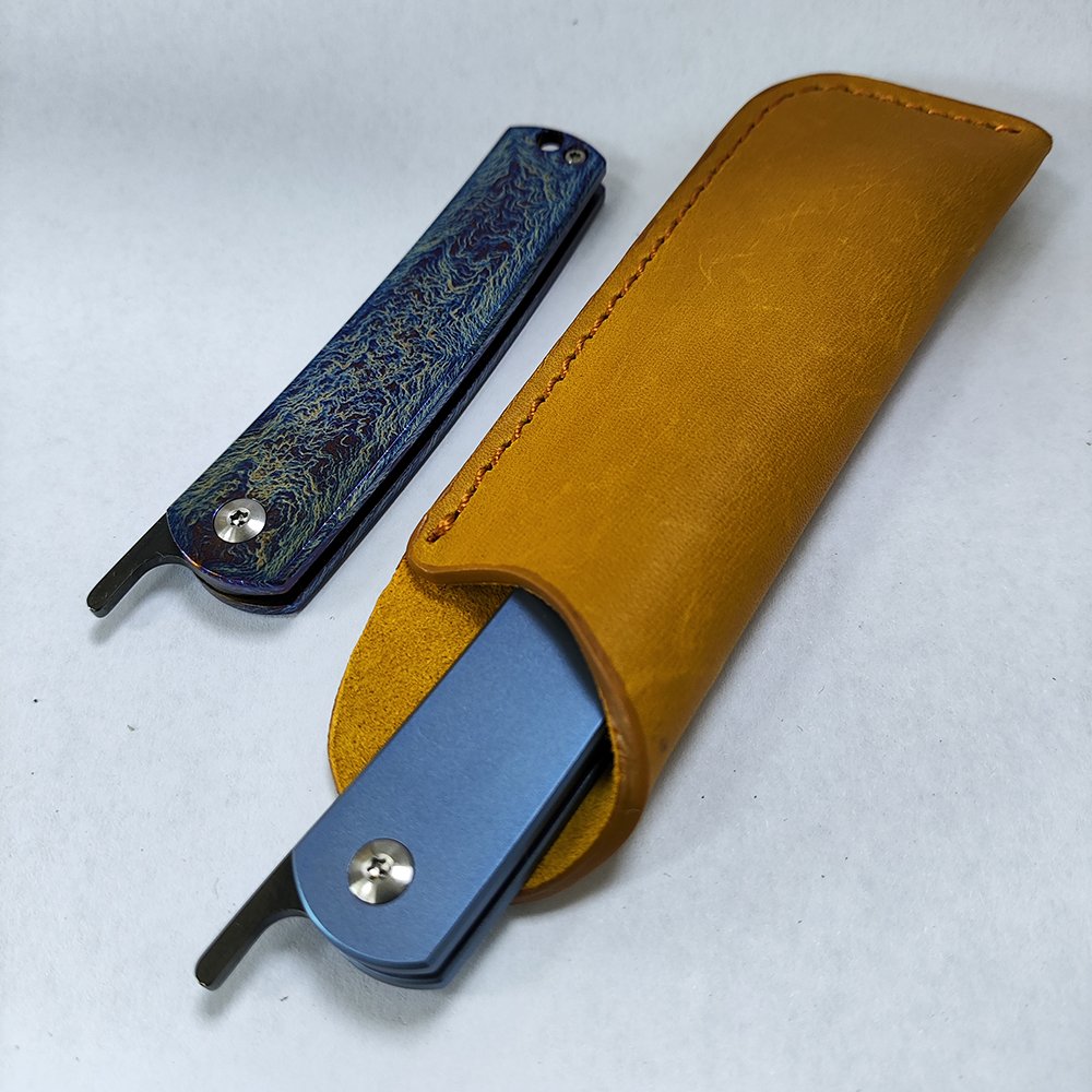 An outdoor high nitrogen steel folding fruit knife with a small knife, titanium alloy handle, and a small knife with a camper
