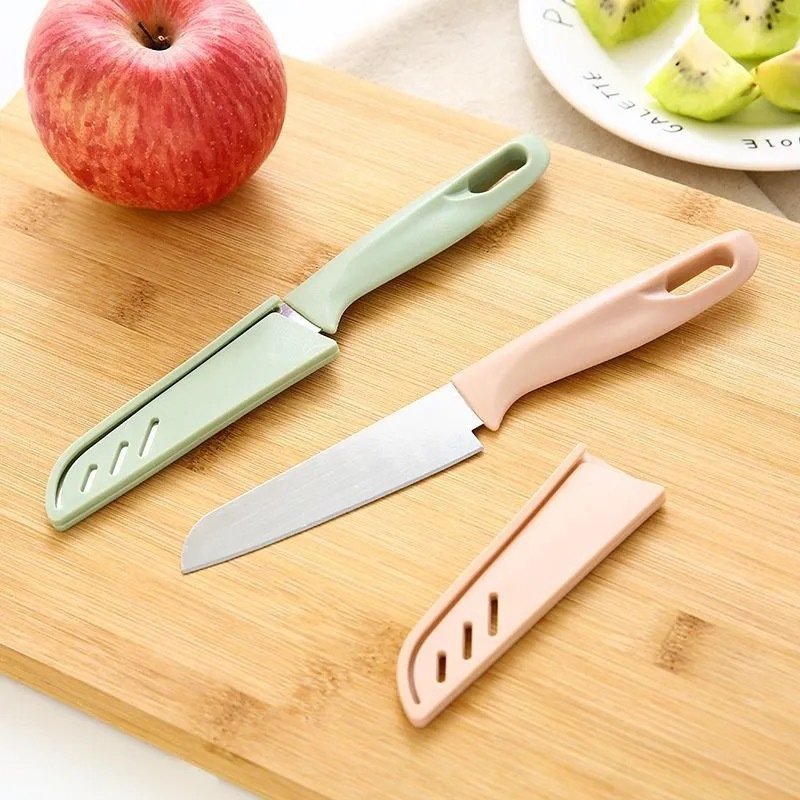 Fruit and steel cutter with a knife in the kitchen