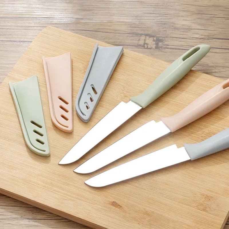Fruit and steel cutter with a knife in the kitchen