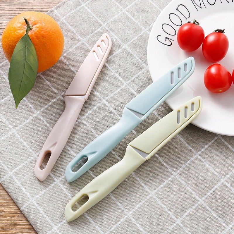 Fruit and steel cutter with a knife in the kitchen