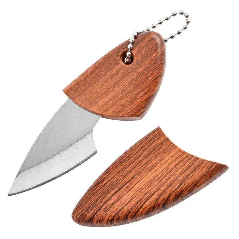 THE LITTLE FAT DOLPHIN KNIFE, THE LITTLE POCKET KNIFE, TOOK A WOODEN FISH KNIFE TO CAMP OUTSIDE, AND THE T-SHIRT WAS REMOVED