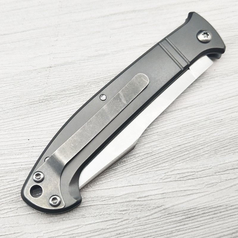 A high-heavy folding knife in the open and a fruit knife to survive
