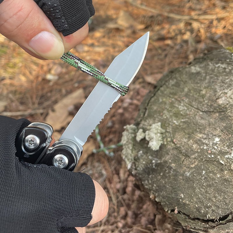 An outdoor multifunctional combination of knives and scissors and a camp camp camp camp tent with a hammer and nail