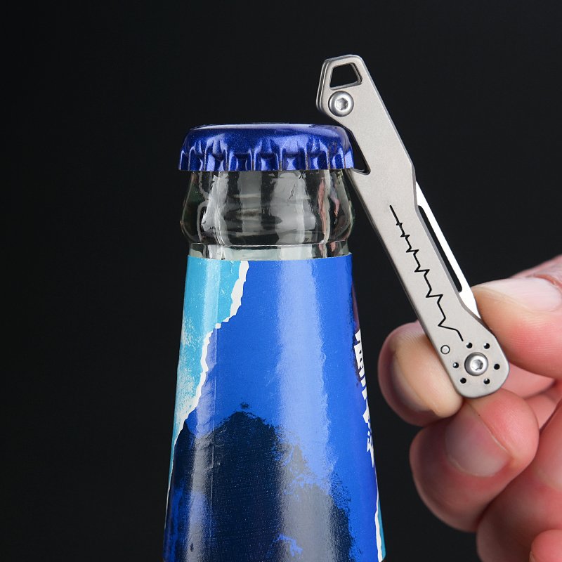 A multi-purpose titanium alloy knife can open a bottle of a key knife and fold a paper knife