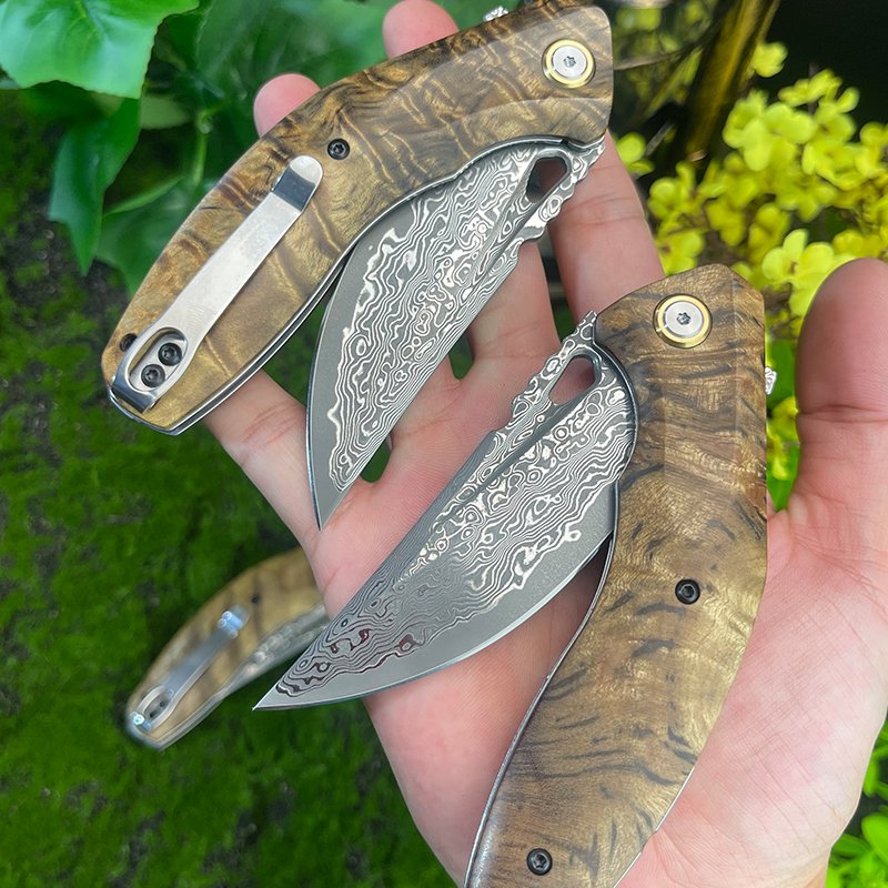 The Damascus steel field camping with a folding knife outside the house