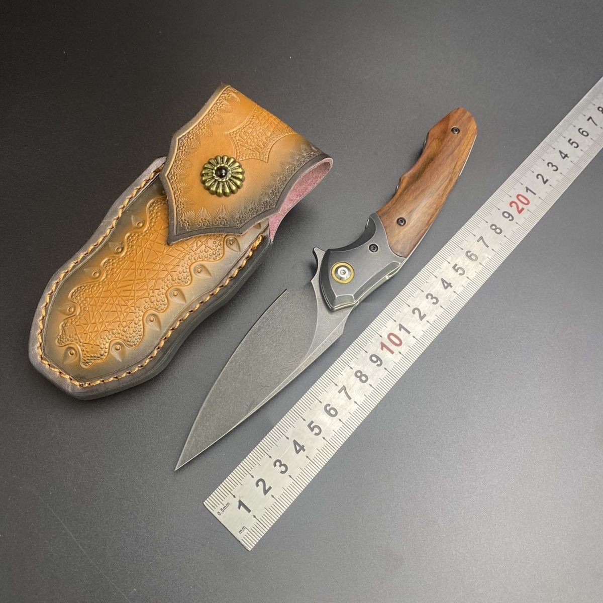 Uzi Phoenix camping outside with multipurpose knives