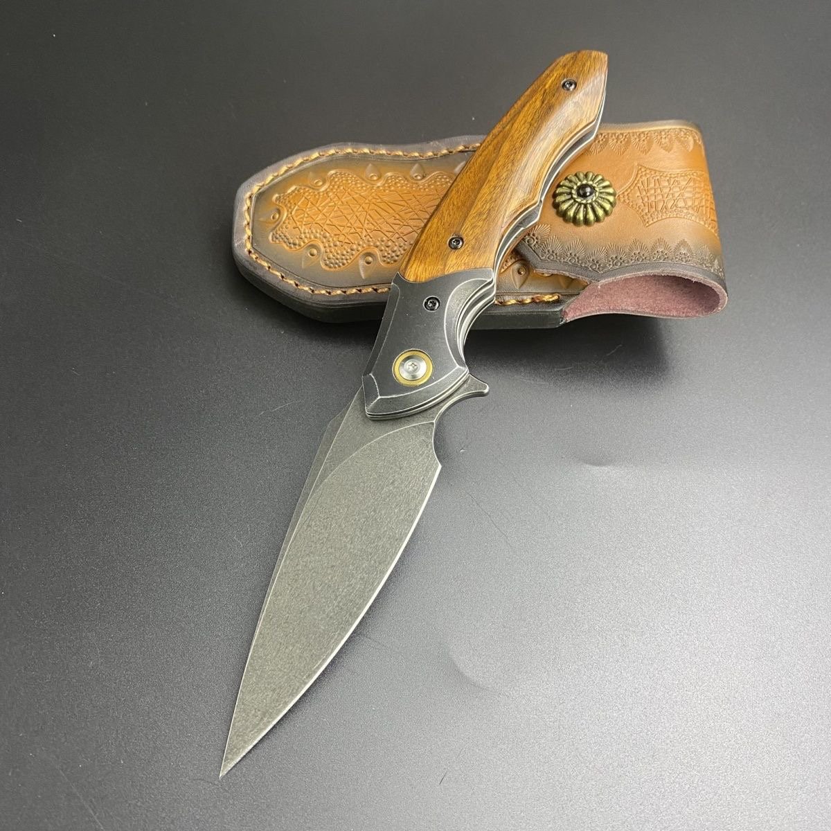 Uzi Phoenix camping outside with multipurpose knives