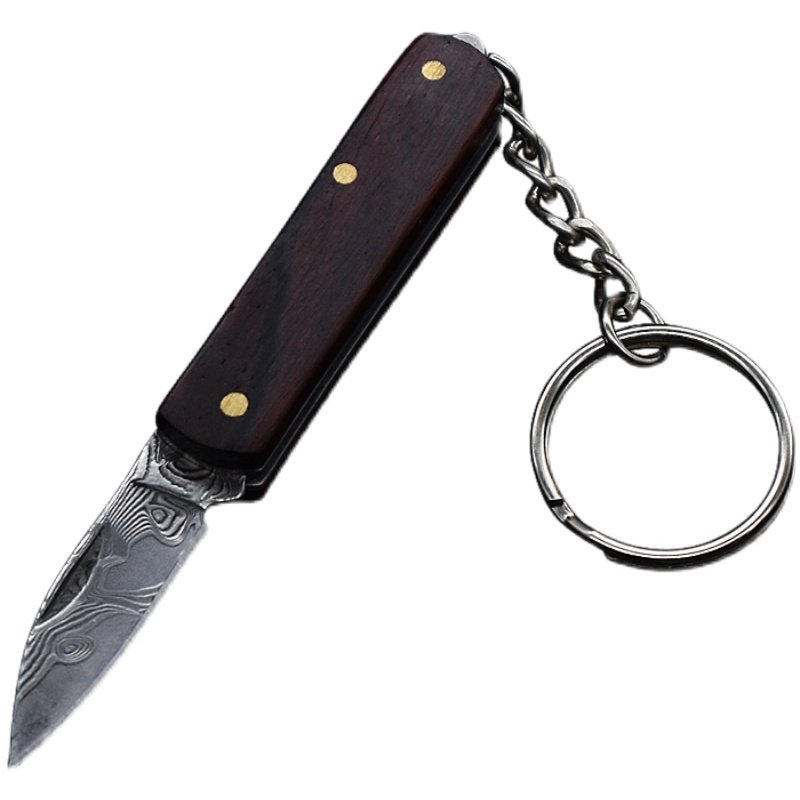 A small, folding knife, a practical fielding knife and a key-button with a mini-Damascus knife