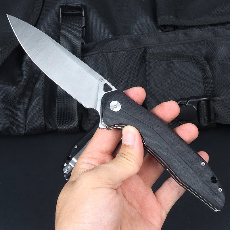 A D2 STEEL KNIFE, A MULTI-PURPOSE FOLDER, A HIGH-STRENGTH, CAMPING KNIFE, AND A MOUNTAIN CAMPER