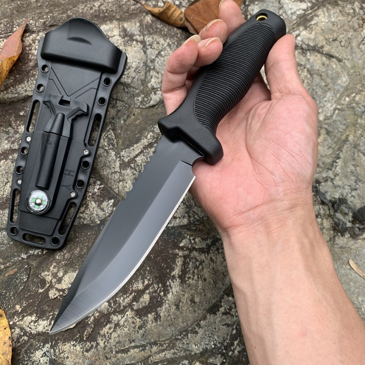 An outdoor knife with a multi-purpose straight blade and a high-intensity defensive knife camp