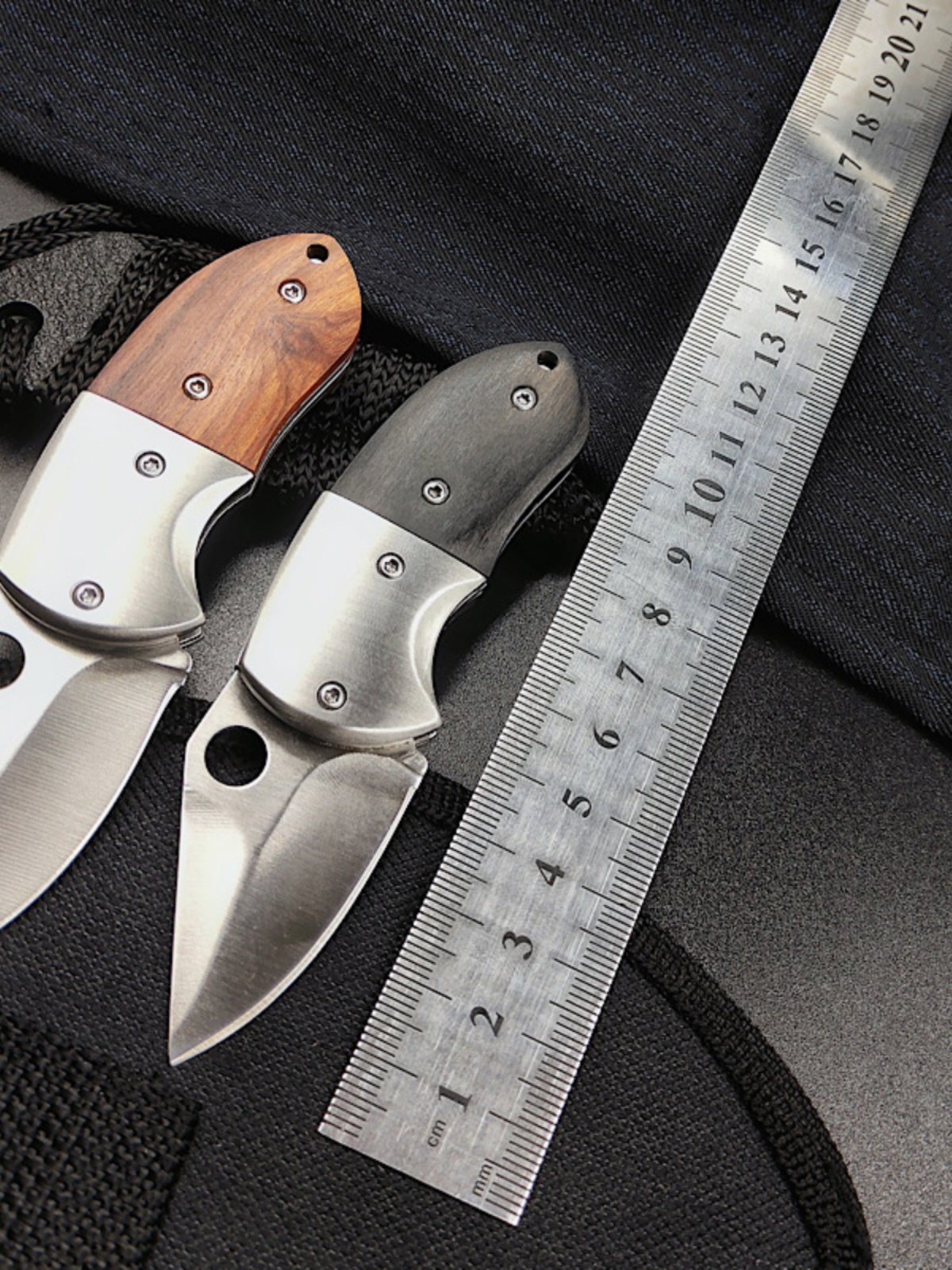 A small knife, a folding knife with a key button and a stainless steel fruit knife