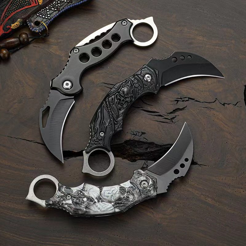 A knife with a mini-hawk claw and a coyote and a fruit knife with a machete