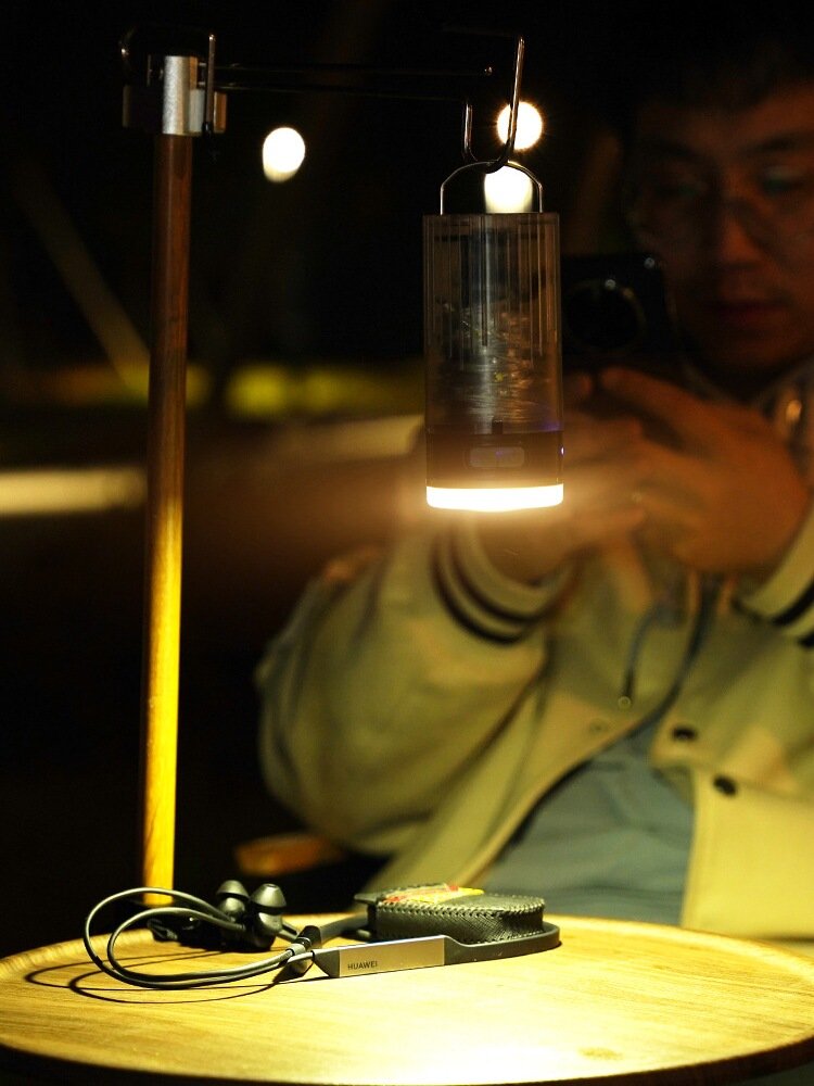 The outdoor camper rolls out a camper light with a household emergency light