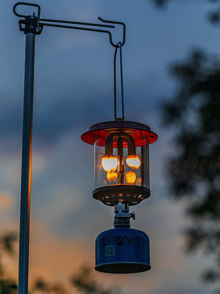 OUT-D CAMPLIGHTS WITH TWO-HEADED GAS LAMPS ON THE OUTSIDE OF THE CAMP