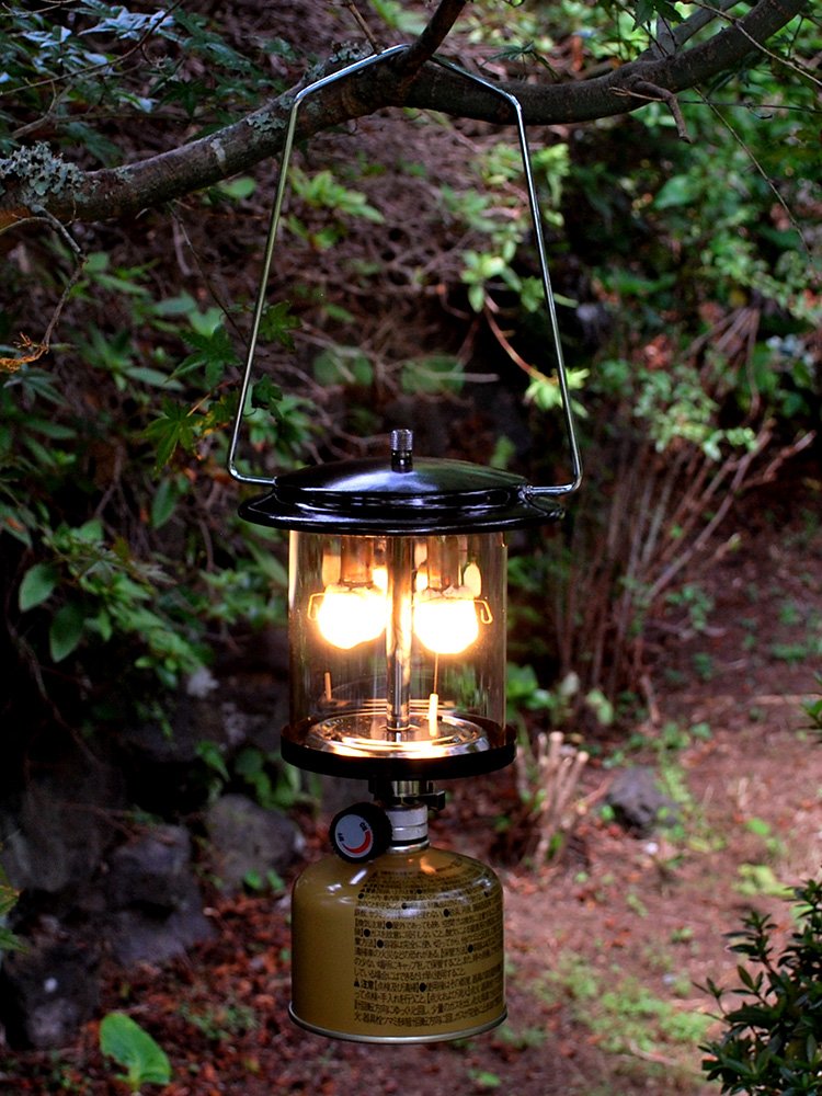 OUT-D CAMPLIGHTS WITH TWO-HEADED GAS LAMPS ON THE OUTSIDE OF THE CAMP