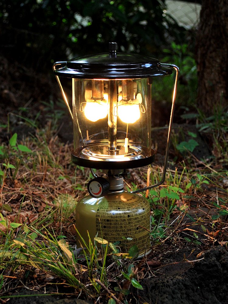 OUT-D CAMPLIGHTS WITH TWO-HEADED GAS LAMPS ON THE OUTSIDE OF THE CAMP