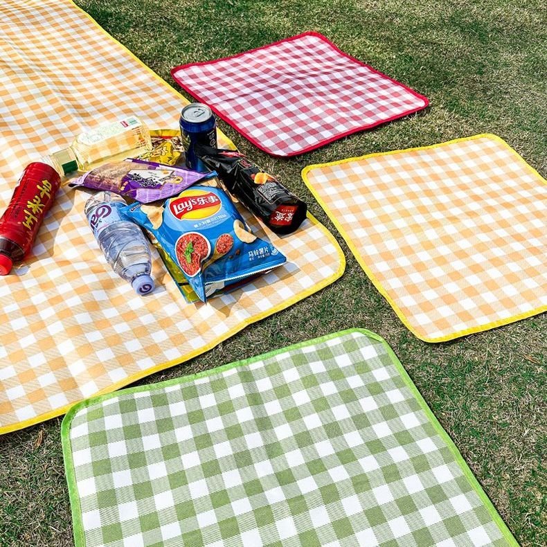 Outdoor folding of small seating pads to separate the dirty water-proof park camping picnic mats from the autumn trip