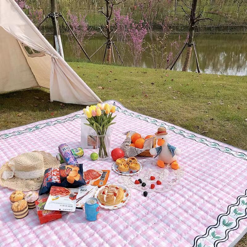 A picnic mat with extra and thick picnic cloth and a camper