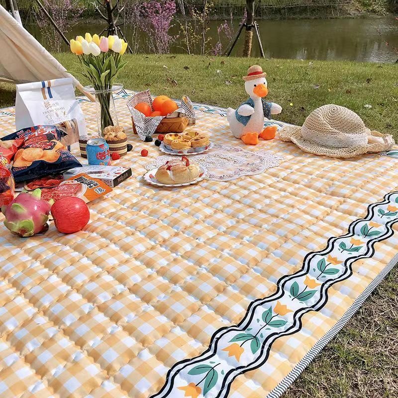 A picnic mat with extra and thick picnic cloth and a camper