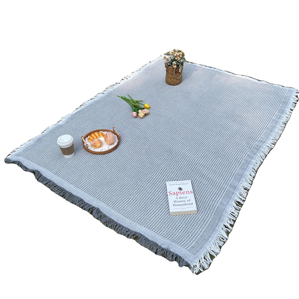 a picnic mat outside the house, with a thicker lawn, and a beach mat for the bonnet music festival