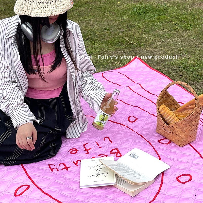 A picnic mat with a thick outdoor flood-proof pad folds and a camp mattress with a water-proof camper