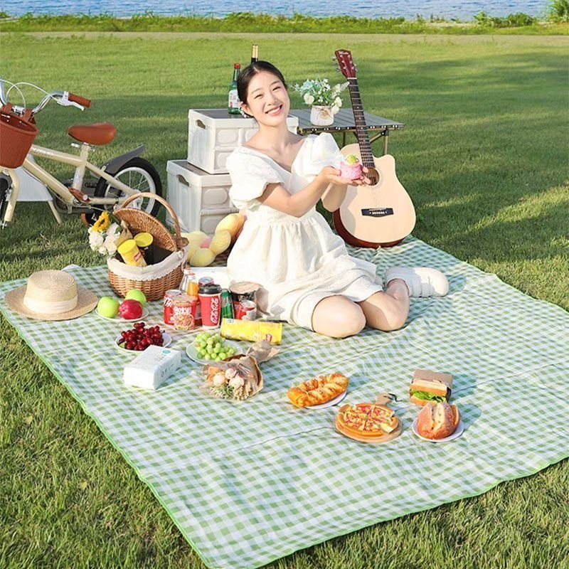 A picnic mat for the outdoor cooking camp tent with water and camping mats for the field