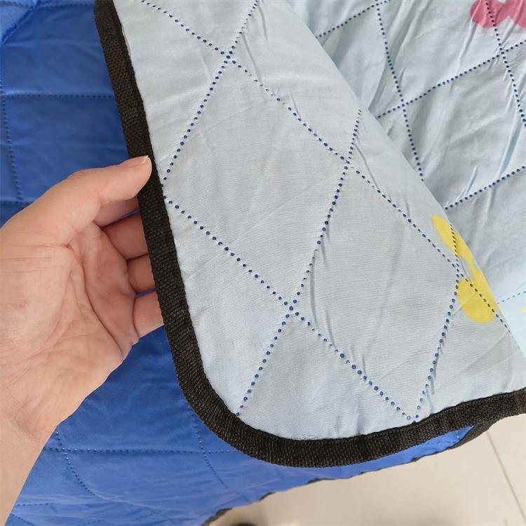 An outdoor picnic mat with an Oxford camper park tent folded