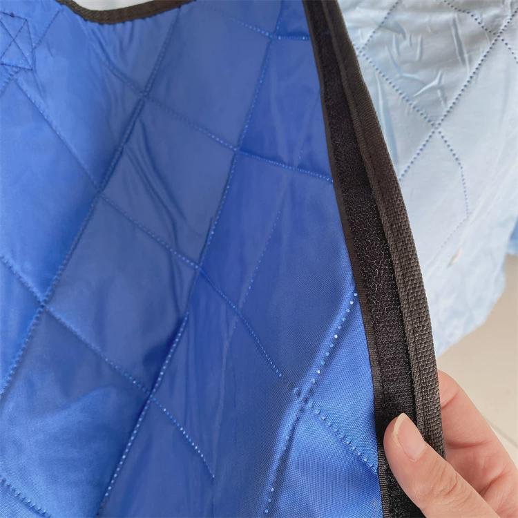 An outdoor picnic mat with an Oxford camper park tent folded