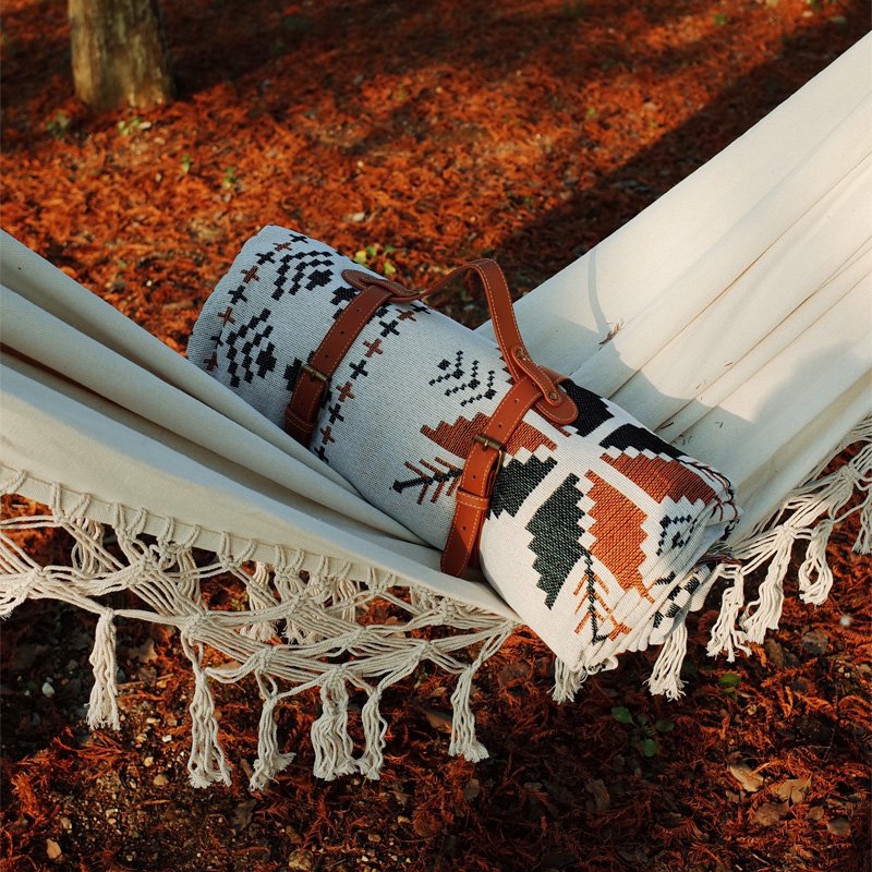 A picnic mat with a thick tent, a camping blanket, and a beach mat for the spring camp