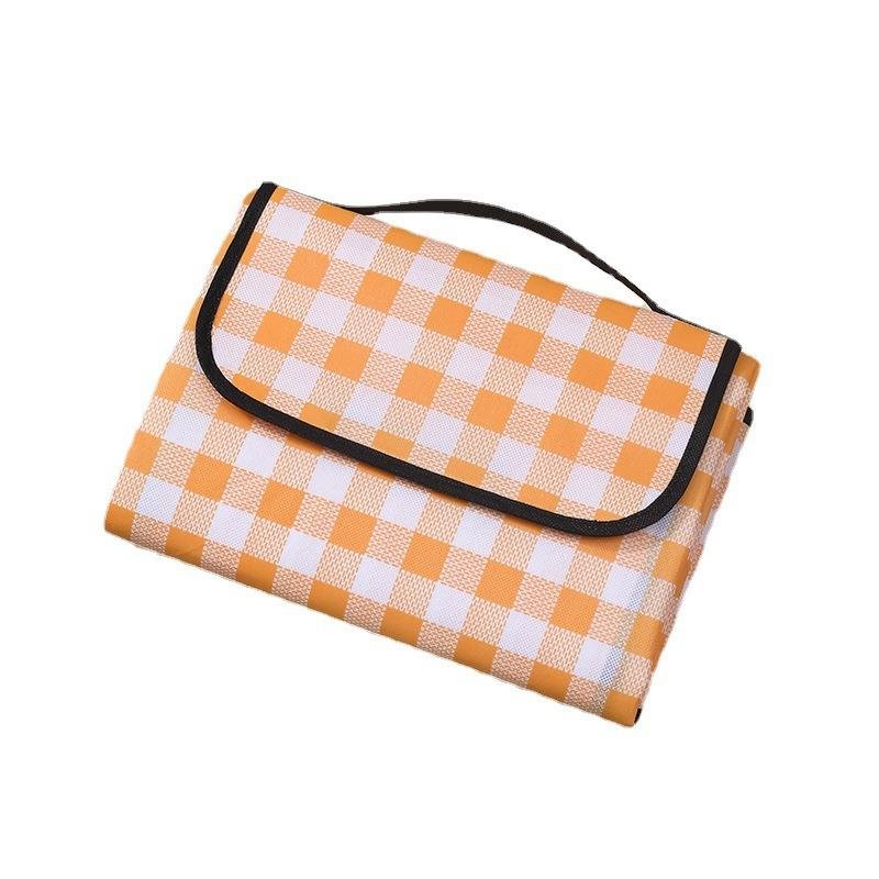 A picnic mat for the outdoor cooking camp tent with water and camping mats for the field