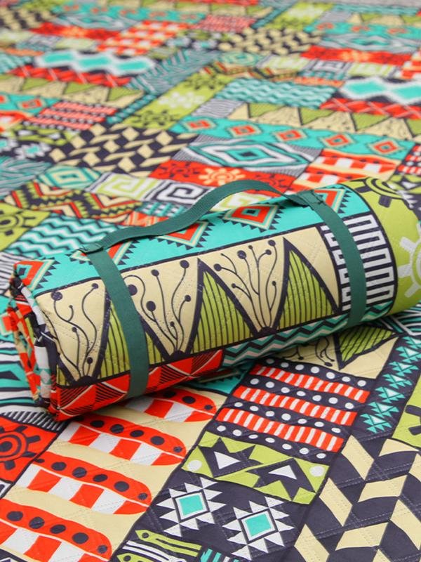 A picnic mat with an outdoor tent with a mattress in the lawn park and a watercooking pad thicken
