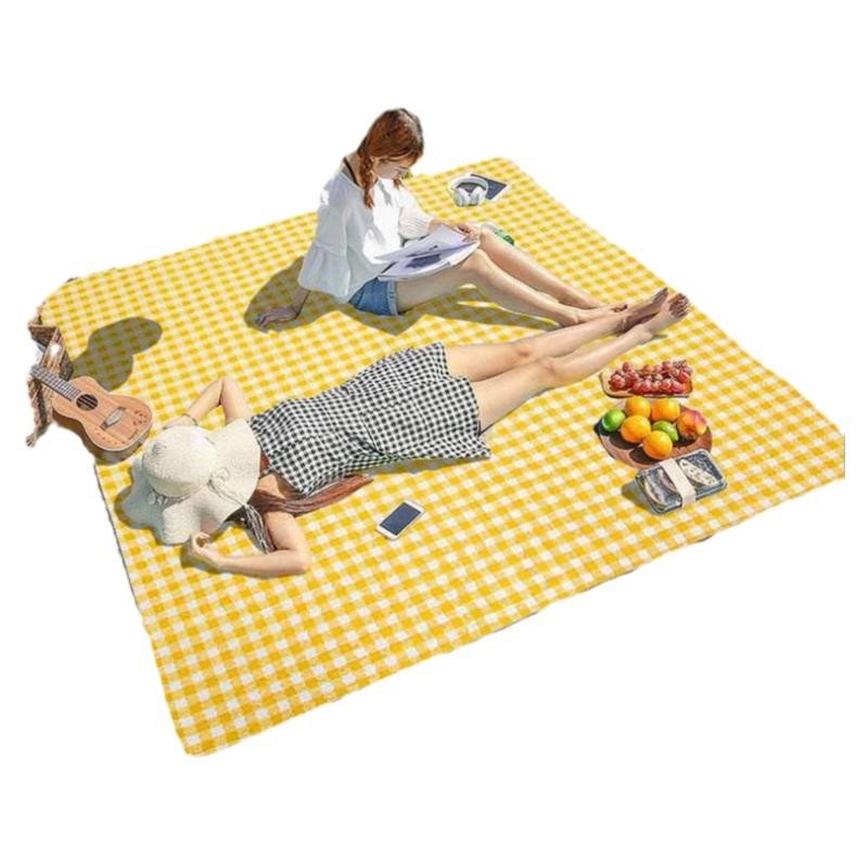 A picnic mat with a thick picnic cloth and a camping tent with a camping pad
