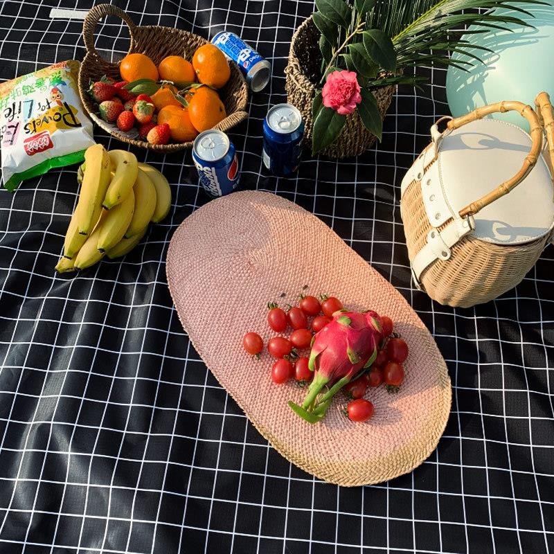 An outdoor plaid picnic pad with a hot-tide cooker and a puddle-proof camper
