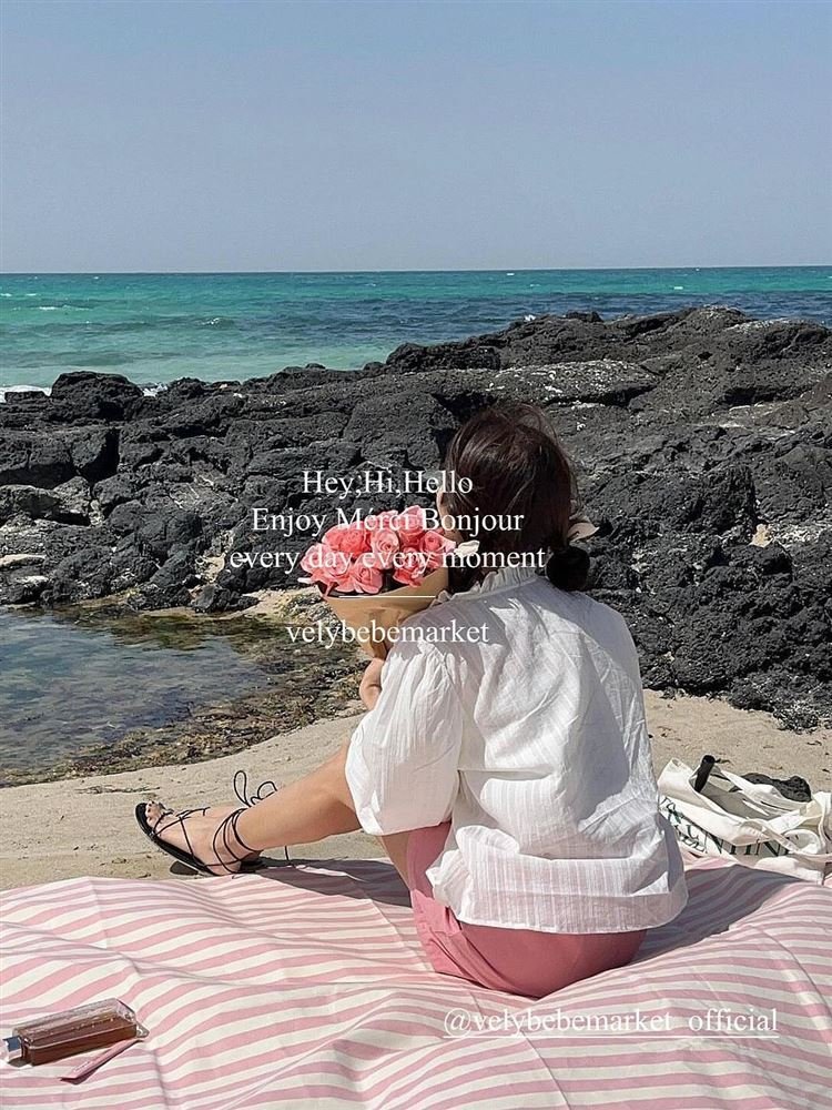 a striped picnic on a beach with a waterproof, sand-proof, open-sea-side camping pavilion with a tablecloth
