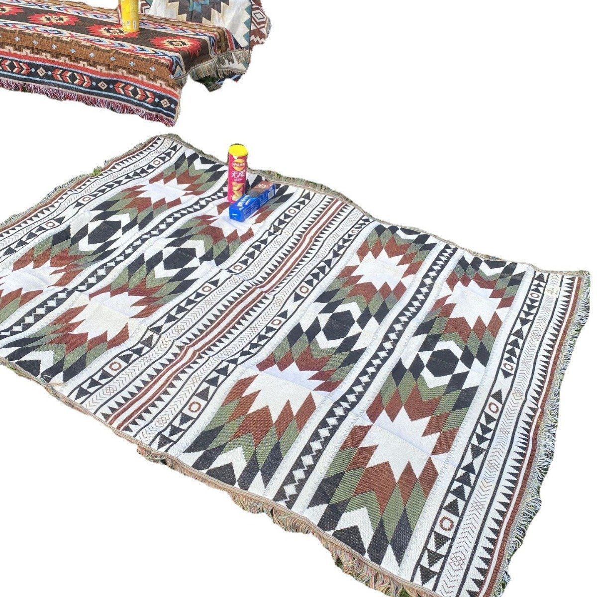 a picnic mat in a camping blanket and an outdoor pavilion of table decorations